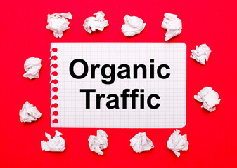 On a bright red background, white crumpled sheets of paper and a sheet of paper with the text...