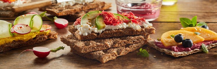 Delicious crispbread toasts served on wooden table