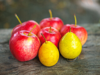 Delicious country apples and pears on the bench with the space for your text, selective focus, beautiful blur.
