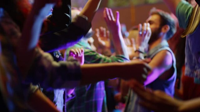 Footage of a crowd or group of young, stylish multi-ethnic people during colorful party in different clothes . Dancers having fun dancing at a party . Shot on RED HELIUM Cinema Camera in slow motion .