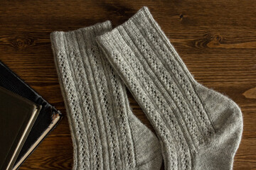 Fototapeta na wymiar Dark gray knitted men socks close up, woolen texture
