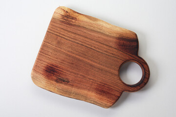 Rustic wooden chopping board on white background