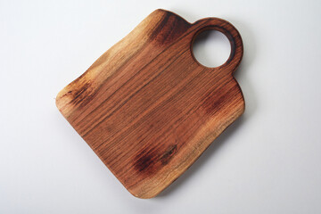 Wooden cutting board on white table