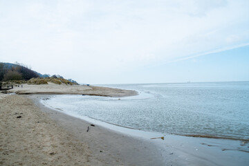 Top view of a beach washed by sea water, with rocks. Wet sand is drawings rivers and stones. High quality photo