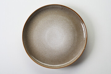 Flat ceramic plate on white background