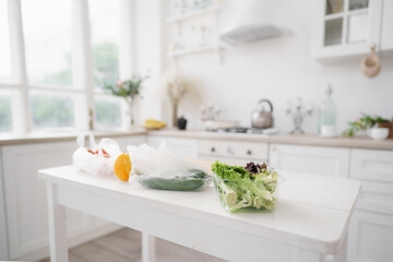 Fototapeta na wymiar Fresh vegetables and lettuce on white wooden kitchen table
