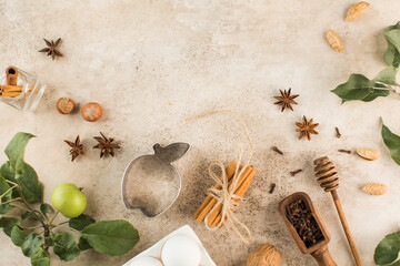 Ingredients for baking apples. Apple, cinnamon sticks, spicy spices and eggs on a brown background. Copy space.