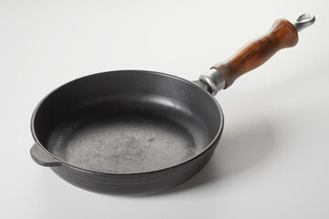 Cast iron frying pan with wooden handle