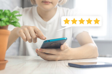 Satisfied customer giving five star rating for the service, feedback icon with smartphone in hand