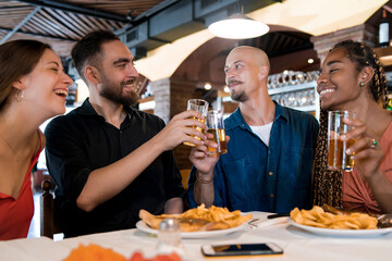 Group of friends enjoying a meal together at a restaurant.