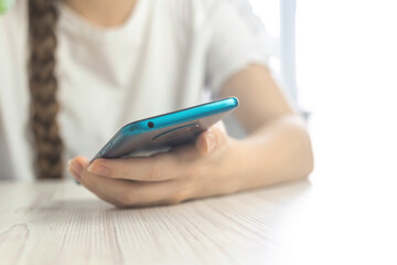Close-up young woman use smartphone, concept of search for information online on the internet and social media, using technology and social media photo