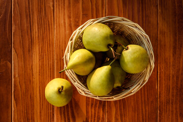 Healthy Organic Pears in the Basket on wooden rustic background. Fresh pears from the farm. Healthy...