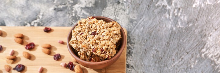 Healthy food. Oatmeal dessert. Almond, cranberry, peanut, honey. Cereal homemade snack at bowl. Crispy brown buscuit. Whole grain breakfast