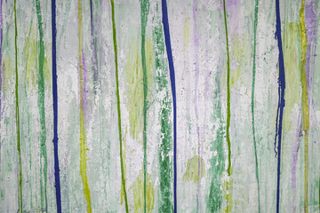 Abstract paint background. Colored lines and splashes of acrylic paint on a white wall surface
