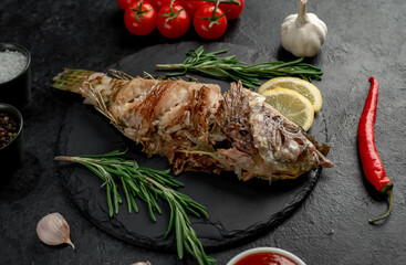grilled parrot fish on stone background 