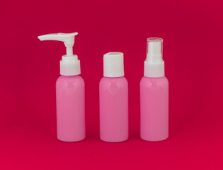 Three cosmetic bottles with white caps