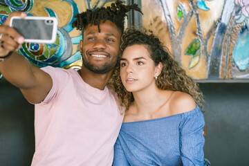 Couple taking a selfie with a mobile phone.