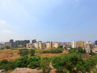 Obraz premium City view with modern and old buildings. Greenery near the city