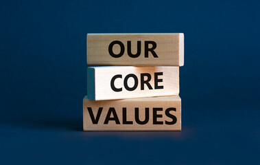 Our core values symbol. Concept words 'Our core values' on wooden blocks on a beautiful grey...