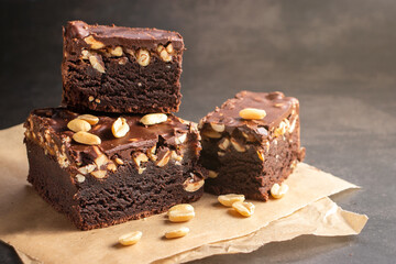 Brownie cake in a close-up on parchment paper in a close-up on a gray background