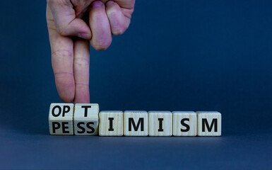Pessimism or optimism symbol. Businessman turns cubes and changes the word 'pessimism' to...