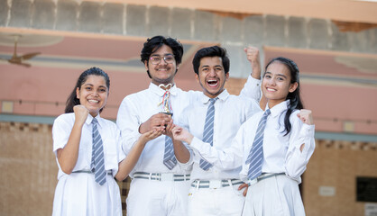 Group of excited  school students Celebrating success and winning 