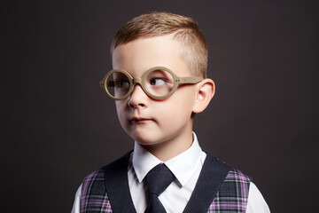 funny child in glasses and siut. genius Kid