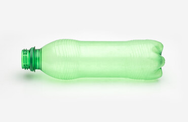 Used transparent green plastic bottle on an isolated white background