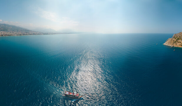 Aerial wide view of Alanya Turkey, Summer morning. Travel and vacation. Ships and boats. Kızılkule bay. lighthouse and pier. Copy space Show program and entertainment for tourists, swimming