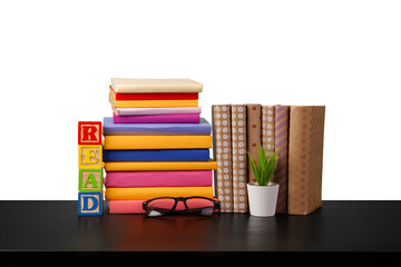 Stack of books on wooden table against white background