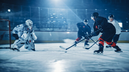 Ice Hockey Rink: Professional Forward Player Breaks Defense, Prepairing to Shot Puck with Stick to Score Goal. Two Competitive Teams Play Intense Game.