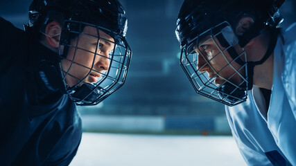 Ice Hockey Rink Arena Game Start: Two Professional Players Aggressive Face off, Sticks Ready. Intense Competitive Game Wide of Brutal Energy, Speed, Power, Professionalism. Close-up Portrait Shot - Powered by Adobe