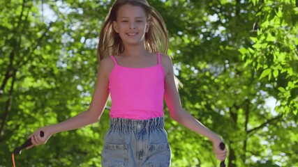 Cute preteen girl with jumping rope in park - Powered by Adobe