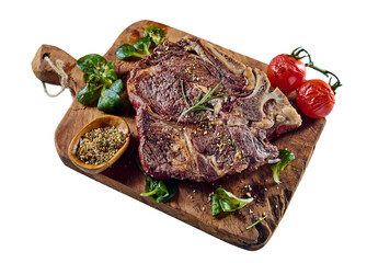Roasted meat with leaves and tomatoes on wooden board