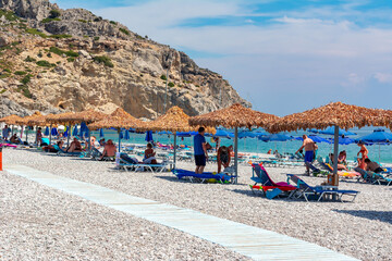 Umbrellas and sunbeds on Traganou beach, Rhodes island, Greece