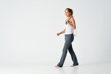 sports woman exercising with skipping rope fitness light background