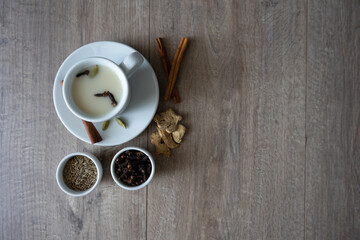 masala tea surrounded by spices on the table