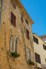 Fototapeta na wymiar An old stone residential building in the historic medieval coastal town of Porec in Istria, Croatia 