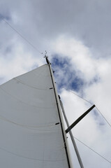 White Sail Under Cloudy Sky