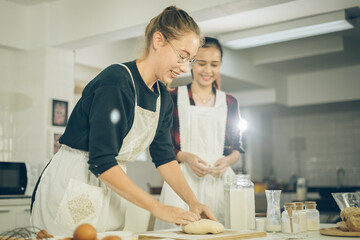 Smile Two females make bakery in the kitchen