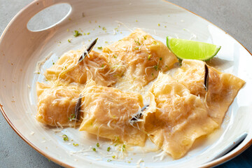 Italian dish ravioli with parmesan in a plate