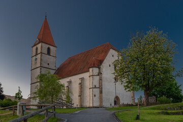 Fototapeta na wymiar Semriach village with white church in sunny summer morning