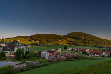 Fototapeta na wymiar Semriach village with Schockl hill over in sunset sunny morning