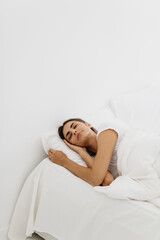 Obraz na płótnie Canvas Beautiful young woman sleeping on white background.