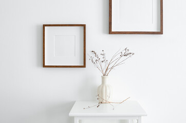 Frames mockup on white wall for photo or print presentation. Minimalistics style indoor interior with artwork mockup.