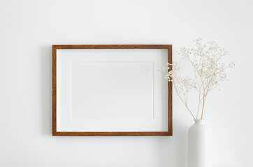 Landscape wooden frame mockup with copy space for artwork, photo or print presentation. White wall...