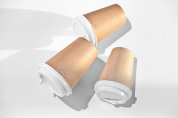 cups of coffee to go made of eco material, cardboard and reusable plastic lids. take away coffee and drinks concept.