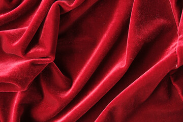 abstract texture of draped red velvet background. eautiful textile backdrop. Close-up. Top view
