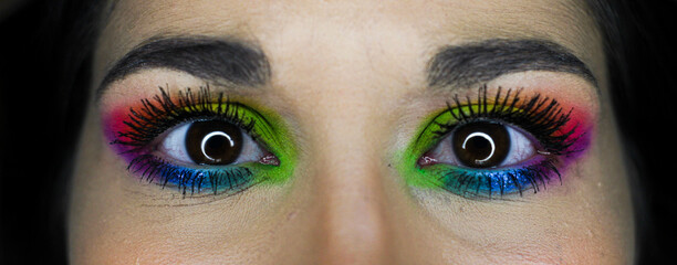 eye-catching vivid makeup eye details of a young girl. LGBT homosexual flag makeup