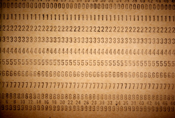Closeup of perforated punched card, obsolete data storage. Vintage unused computer punch cards used for programming and data entry in the sixties and seventies